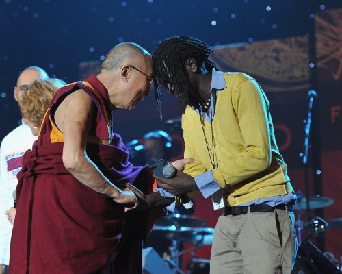 SYRACUSE, NY - OCTOBER 09: His Holiness the Dalai Lama speaks with Emmanuel Jal onstage at the One World Concert at Syracuse University on October 9, 2012 in Syracuse, New York. (Photo by Larry Busacca/Getty Images for Syracuse University)
